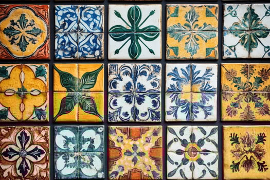 Colorful vintage ceramic tiles forming an ornamental pattern are decorating a wall photo