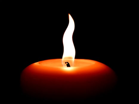 Black background with burning candles photo