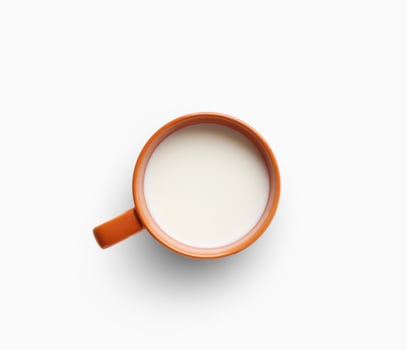 Cup of milk isolated on white background, top view. Eco farm dairy products concept photo