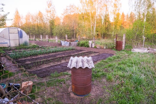 moscow, russia, 10.05.2025 A garden with a barrel in the middle of it photo
