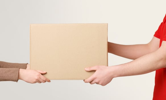 Woman hands accepting delivery of box from deliveryman, cropped, close up, free space photo