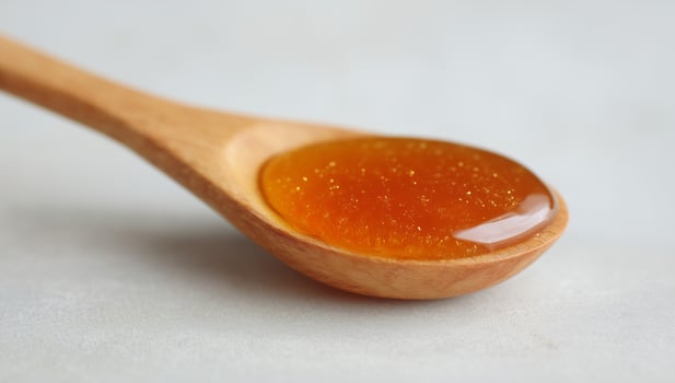 Honey in Wooden Spoon photo