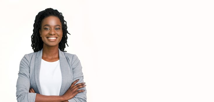 Millennial Businesswoman. Confident black woman in suit posing with folded arms on white background, horizontal banner, wide long shot, panorama photo