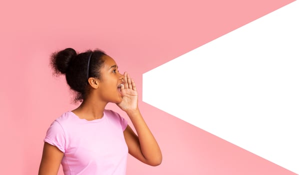 Young girl speaking loud aside to imaginary amplifier holding hand near her open mouth. Side view with empty space photo