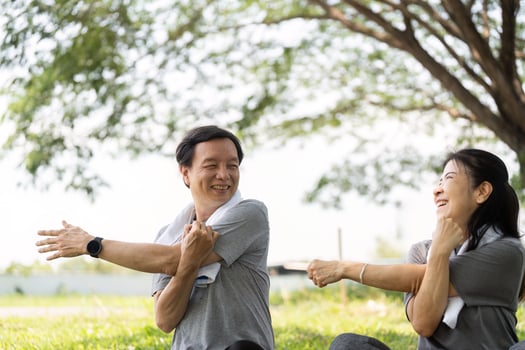 Wellness yoga stretching routine for seniors couple outdoors photo