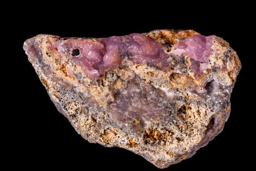 Macro pink, Smithsonite mineral stone on microcline on black background photo