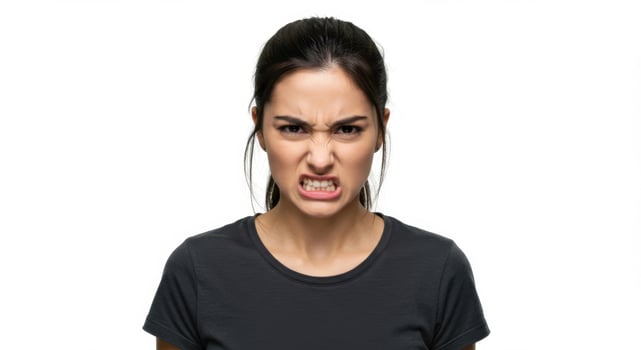 Angry Young Hispanic Woman Gritting Teeth and Frowning in Frustration photo