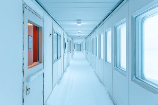 Bright and well-maintained corridor in an Antarctic research facility with multiple rooms photo