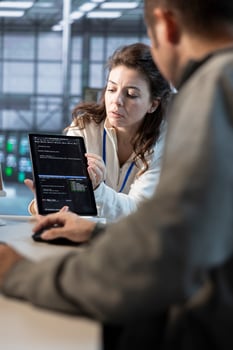 Team on engineers using tablet in data center, managing and optimizing IT infrastructure using network management skills. Server room coworkers upgrading gear with device, reducing operational costs photo