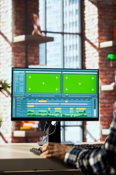 editor polishes raw footage on chroma key PC and improving audio quality. Videographer professionally adjusting clips on isolated screen computer monitor, applying sound effects to film, closeup photo