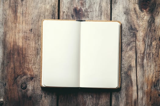 Blank notebook on a wooden table with kitchen items, illuminated by soft natural light for creative mockup photo