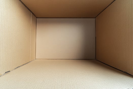 Minimalist cardboard box with blank surface on white background for product mockup in studio lighting photo