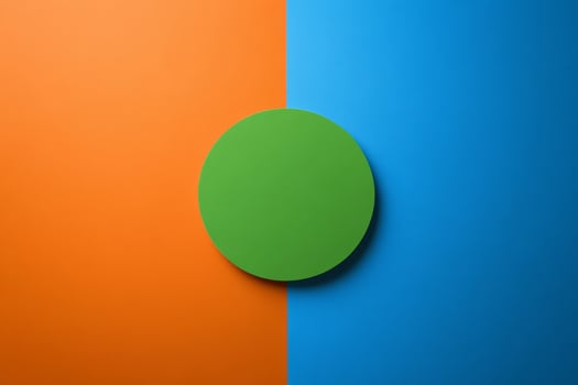 Minimalist design featuring a green circle on a vibrant blue and orange background with contrasting colors photo