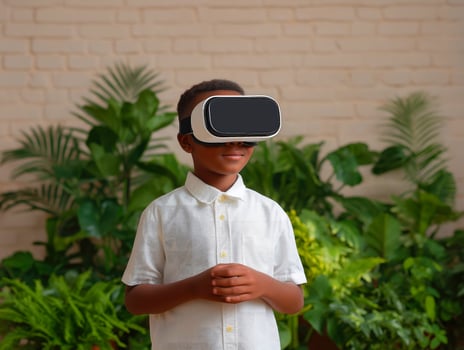Child exploring virtual reality with headset in lush green setting. photo