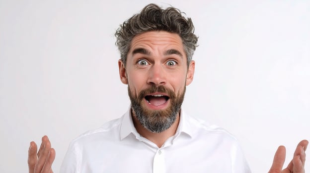 A man with a beard and white shirt is making a surprised face photo