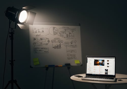 Whiteboard and laptop in dark room photo