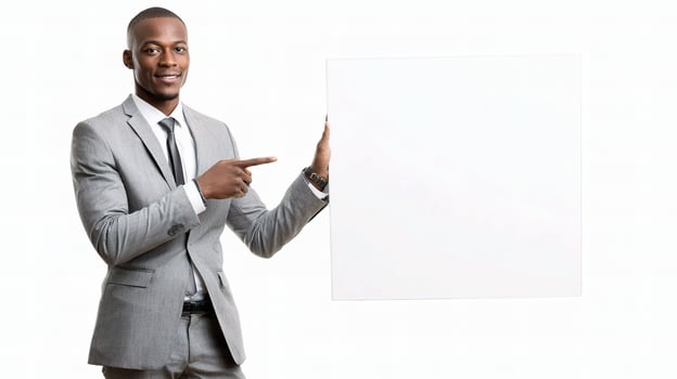 A man in a suit holding up a blank board photo
