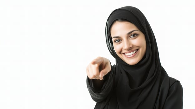 A woman in black hijab pointing at something photo