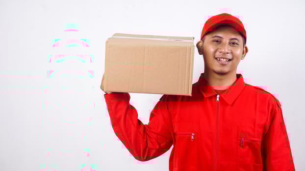 Delivery man in red uniform carrying stack of package box parcel on his shoulder isolated on white background photo