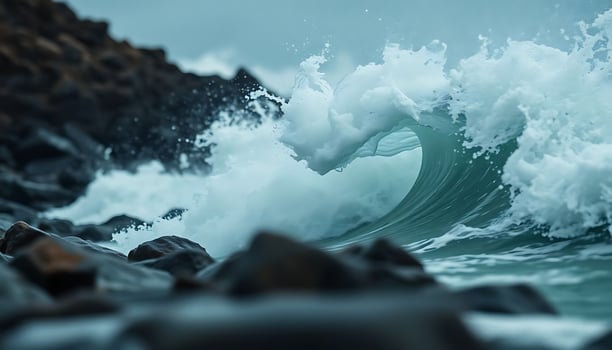 wave is breaking over a rocky shore photo