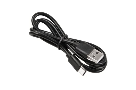 Black USB A to USB-C charging and data cable, coiled and secured with a tie, isolated on white back photo