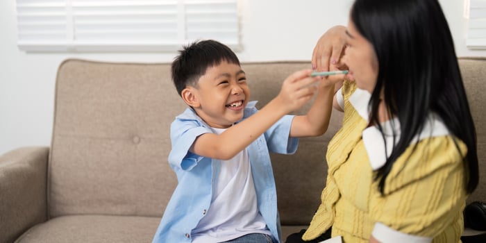 Back to School. Joyful boy playing with mother at home. photo