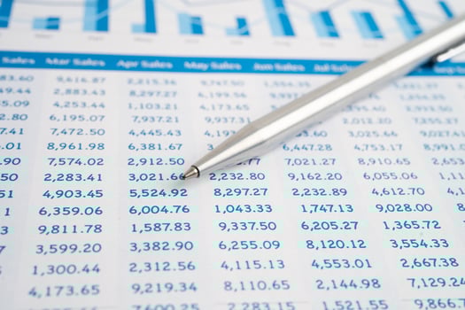 Pen on spreadsheet and graph paper. photo