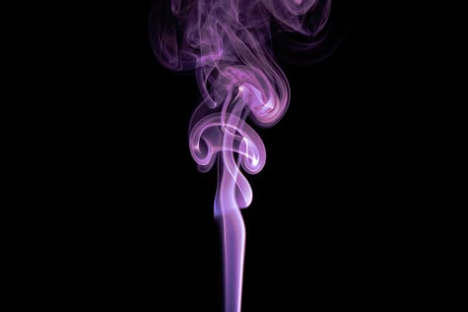 Colorful swirling smoke rising in artistic patterns against a black background photo