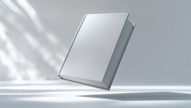 White hardcover book floating in air with dramatic lighting photo