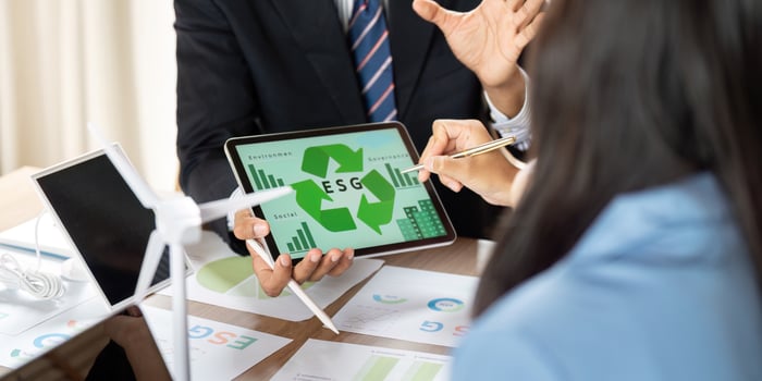 Business Meeting on ESG. Professionals analyzing sustainability metrics and strategies in an office. photo