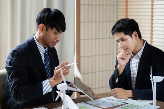 Sustainability Discussion. Professionals analyzing ESG strategies in a modern office meeting. photo