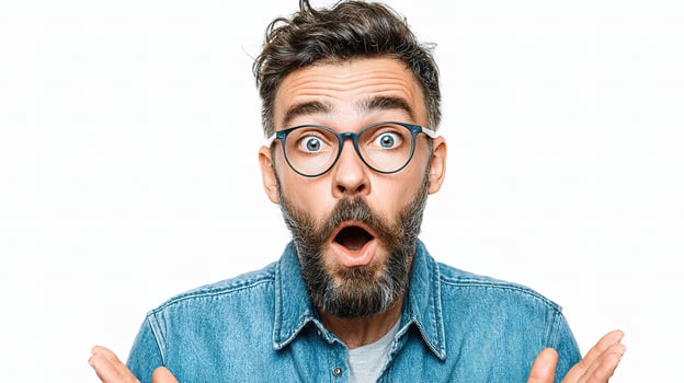 A man with glasses and a beard is making a surprised face photo