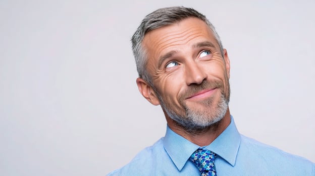 A man with a blue shirt and tie looking up photo