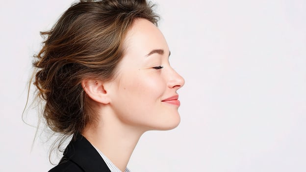 A woman with her eyes closed and a smile photo