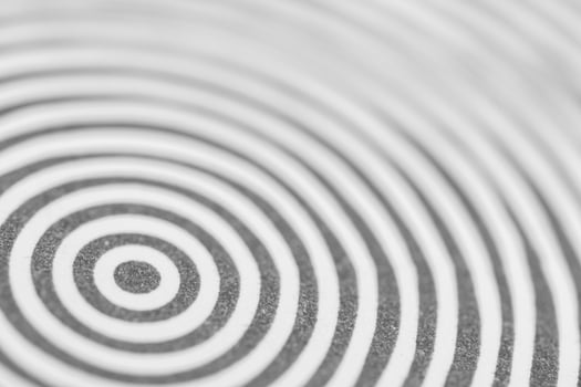 Abstract black and white concentric circles creating a hypnotic pattern. Ideal for backgrounds, concepts of focus, repetition, optical illusions, or design themes photo