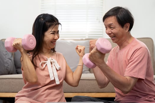 Wellness and Fitness. Elderly couple exercising together with dumbbells. photo