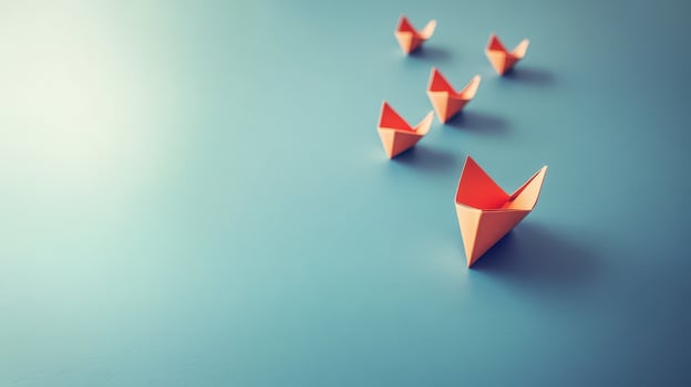 Origami boats line up on blue surface photo