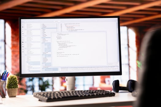 Programming code executing software UI on computer display in apartment office. Close up shot of coding application on PC screen used to write and test code in modern living room photo