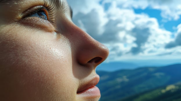 Close-up profile view of a young person gazing skyward. photo