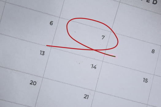 Focus on number 7 in calendar and emptyred ellipse. Save the date. Day of the year concept. photo