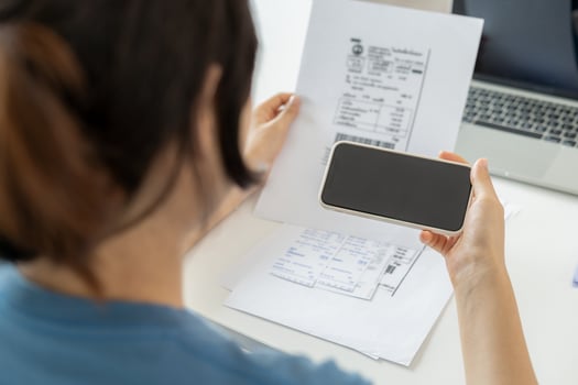 Modern women use phone to scan barcode or QR codes to pay credit card bill after receive document invoice. payment, receive, paying electricity, digital payments without money, technology, scanning photo