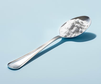 Spoon of a white powder on it photo