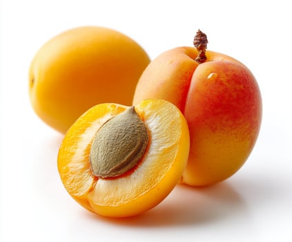 apricots one whole and one cut to show pit photo