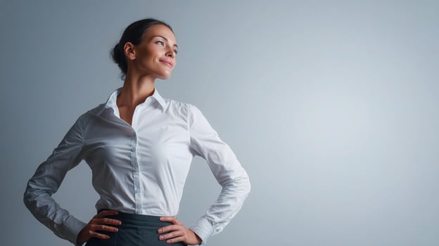 A woman in a white shirt and skirt standing with her hands on her hips photo