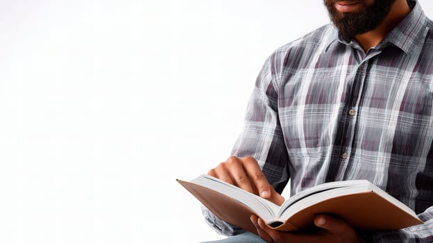 A man with a beard is reading a book photo