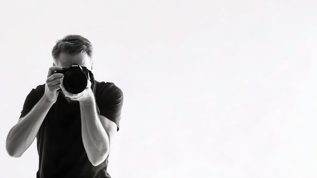 A man taking a picture with a camera photo