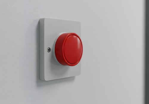 Red emergency button on white wall photo