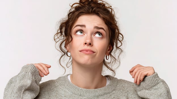 A woman is looking up with her hands on her head photo