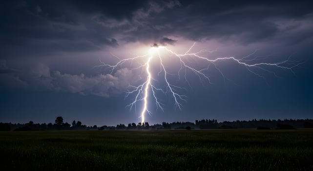 Lightning strikes over a field in the dark photo