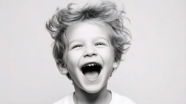 A young boy is laughing and smiling photo